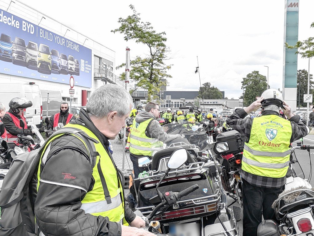 Helfer in Warnwesten satteln auf, bevor der Korso losf&auml;hrt
